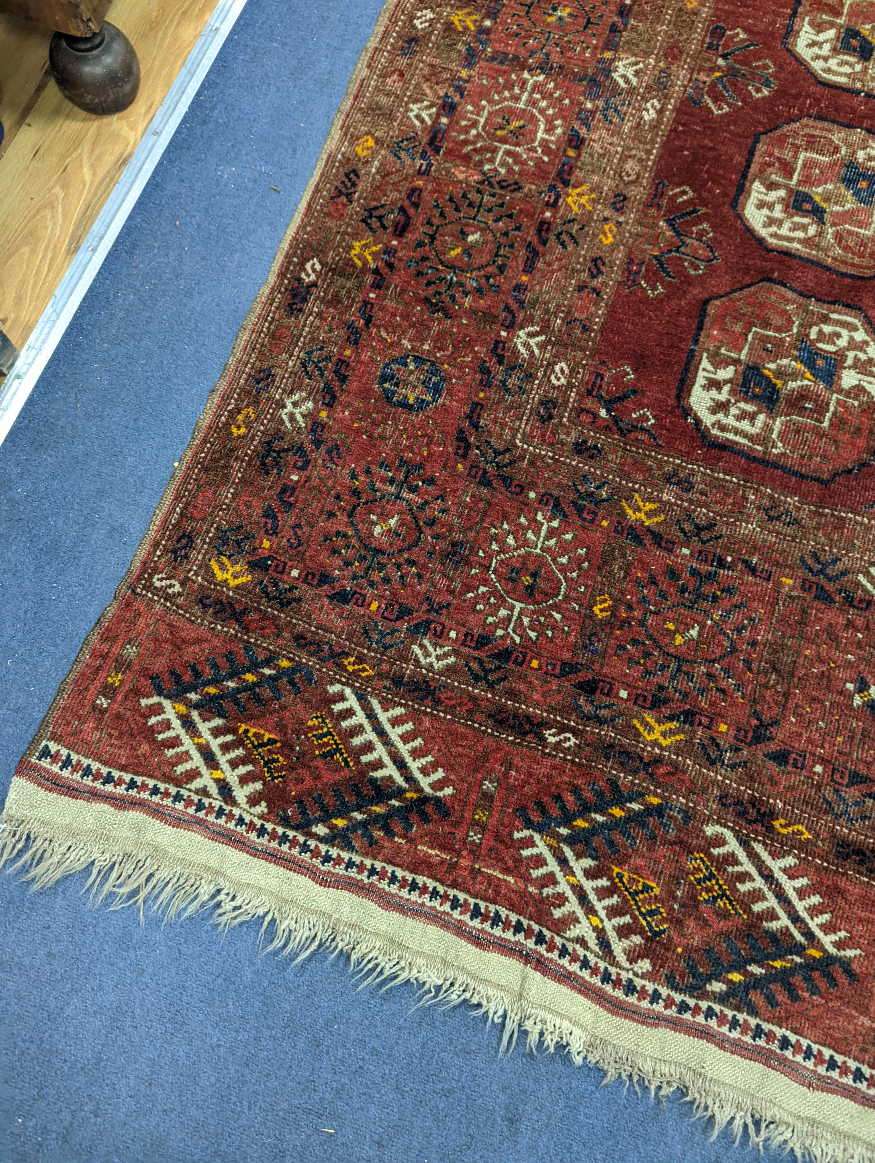 A Bokhara red ground rug, 200 x 114cm